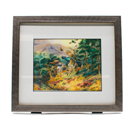 Framed artwork showing capercaillie in flight over a pine woodland with a mountainous landscape in the background.